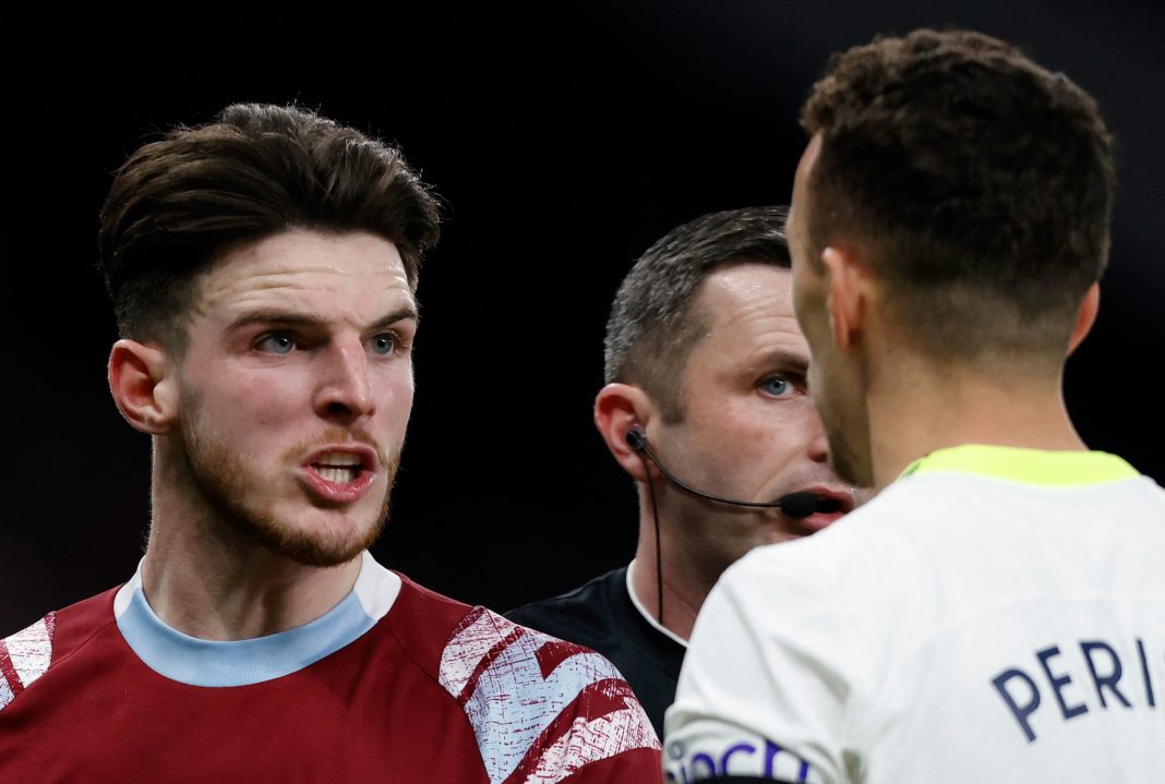 Referee Michael Oliver (C) reacts as Tottenham Hotspur's Tottenham Hotspur's Croatian midfielder Ivan Perisic (R) remonstrates with West Ham United's English midfielder Declan Rice during the English Premier League football match between Tottenham Hotspur and West Ham United at Tottenham Hotspur Stadium in London, on February 19, 2023. (Photo by IAN KINGTON/AFP via Getty Images)
