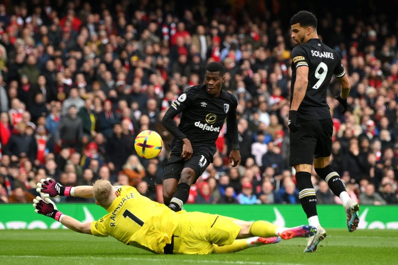 LONDON, ENGLAND - MARCH 04: Dango Ouattara of AFC Bournemouth attempts to shoot as Aaron Ramsdale of Arsenal makes a save during the Premier League match between Arsenal FC and AFC Bournemouth at Emirates Stadium on March 04, 2023 in London, England. (Photo by Shaun Botterill/Getty Images)