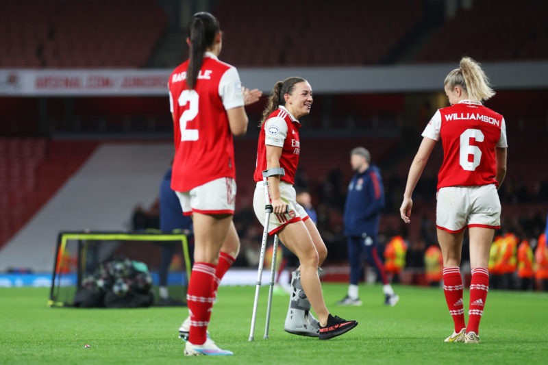 LONDON, ENGLAND - MARCH 29: Katie McCabe of Arsenal, seen with crutches after picking up an injury in the game, speaks with teammate Leah Williamson following the UEFA Women's Champions League quarter-final 2nd leg match between Arsenal and FC Bayern München at Emirates Stadium on March 29, 2023 in London, England. (Photo by Catherine Ivill/Getty Images)
