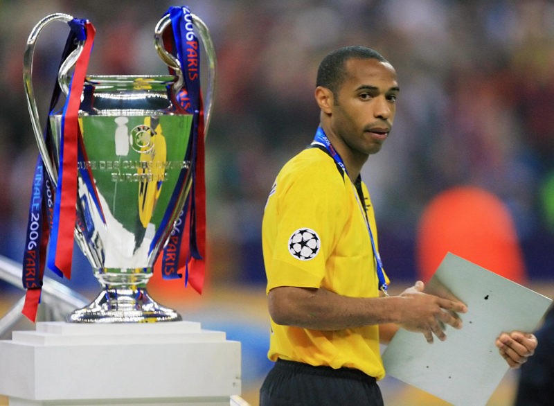 Saint-Denis, FRANCE: Arsenal's French forward and team captain Thierry Henry passes next to the trophy after the UEFA Champion's League final football match Barcelona vs. Arsenal, 17 May 2006 at the Stade de France in Saint-Denis, northern Paris. Barcelona won 2 to 1. (Photo credit ODD ANDERSEN/AFP via Getty Images)