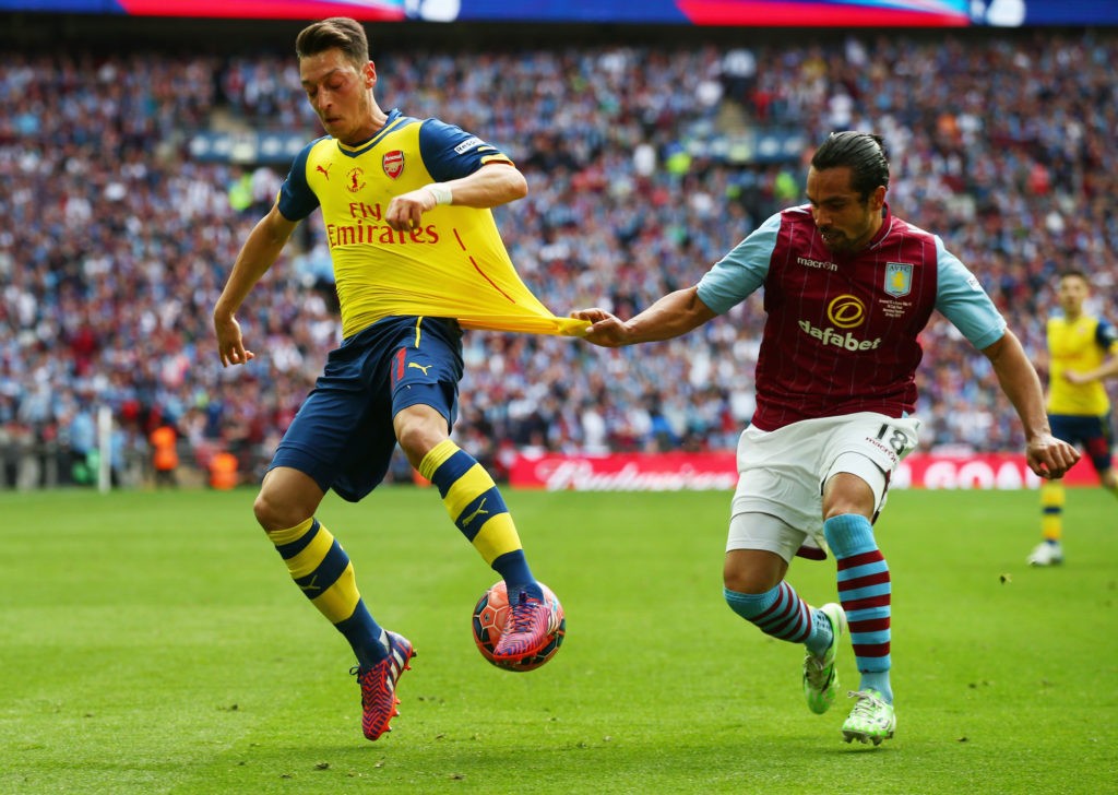 LONDON, ENGLAND: (L-R) Mesut Oezil of Arsenal is challenged by Kieran Richardson of Aston Villa during the FA Cup Final between Aston Villa and Arsenal at Wembley Stadium on May 30, 2015. (Photo by Clive Rose/Getty Images)