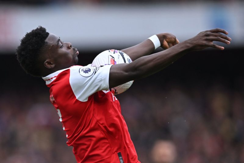 Bukayo Saka, the English midfielder for Arsenal, demonstrates his ball control skills during a Premier League football match against Crystal Palace at London's Emirates Stadium on March 19, 2023. (Photo credit: JUSTIN TALLIS/AFP via Getty Images)