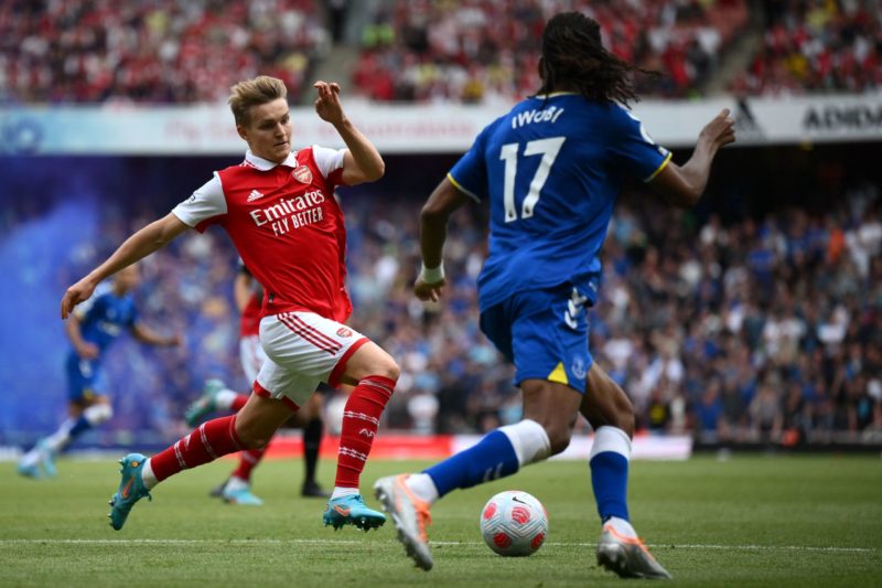 Arsenal's Norwegian midfielder Martin Odegaard (L) challenges Everton's Nigerian midfielder Alex Iwobi during the English Premier League football match between Arsenal and Everton at the Emirates Stadium in London on May 22, 2022. (Photo by DANIEL LEAL/AFP via Getty Images)