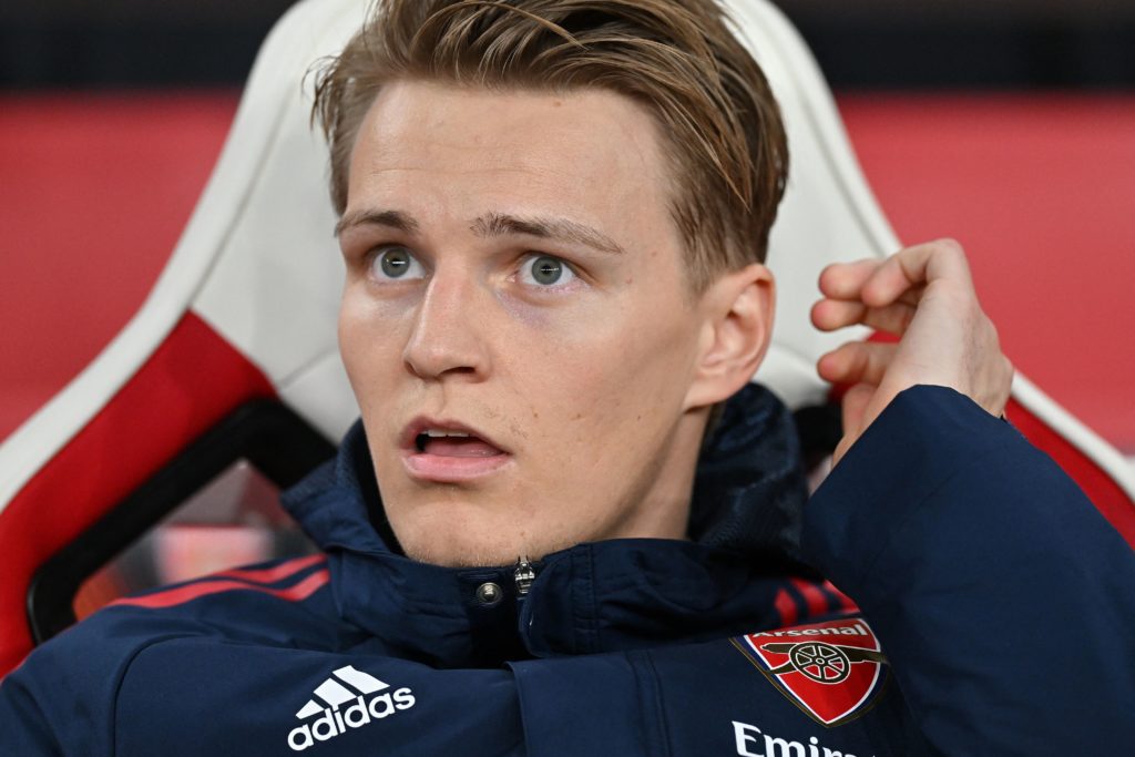 Martin Odegaard, Arsenal's Norwegian midfielder, sits on the bench ahead of the UEFA Europa League round of 16, second-leg football match between Arsenal and Sporting Lisbon at the Emirates Stadium in London on March 16, 2023. Photo credit: GLYN KIRK/AFP via Getty Images.