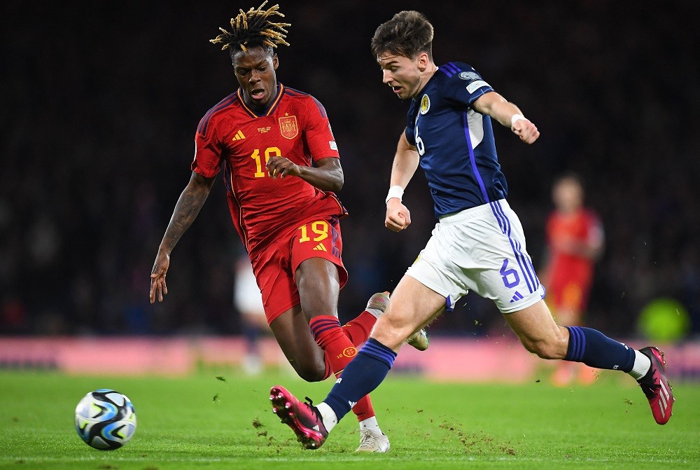 Spain's midfielder Nico Williams (L) vies with Scotland's defender Kieran Tierney during the UEFA Euro 2024 group A qualification football match between Scotland and Spain at Hampden Park stadium in Glasgow, on March 28, 2023. (Photo by ANDY BUCHANAN/AFP via Getty Images)