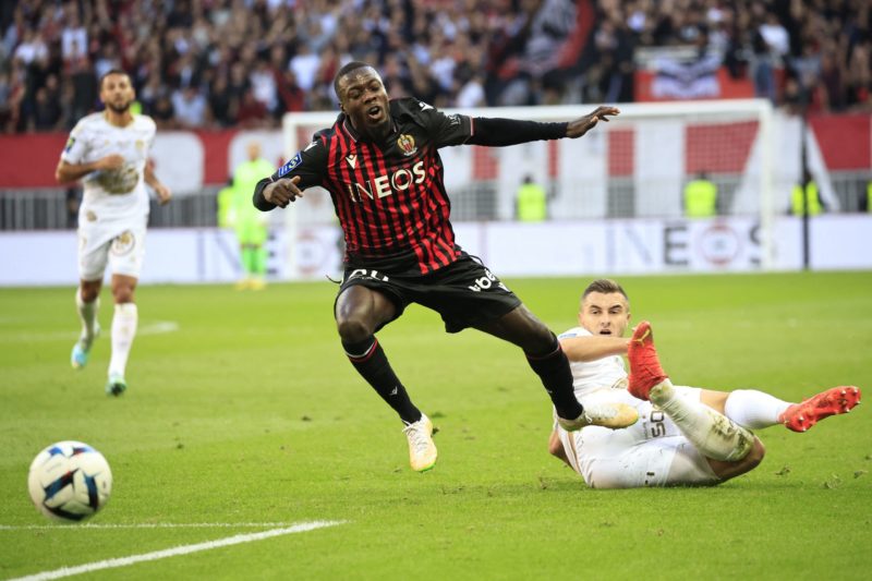 Nice's Ivorian forward Nicolas Pepe (L) fights for the ball with Brest's French defender Brendan Chardonnet during the French L1 football match between OGC Nice and Brest at the Allianz Riviera Stadium in Nice, south-eastern France, on November 6, 2022. (Photo by VALERY HACHE/AFP via Getty Images)
