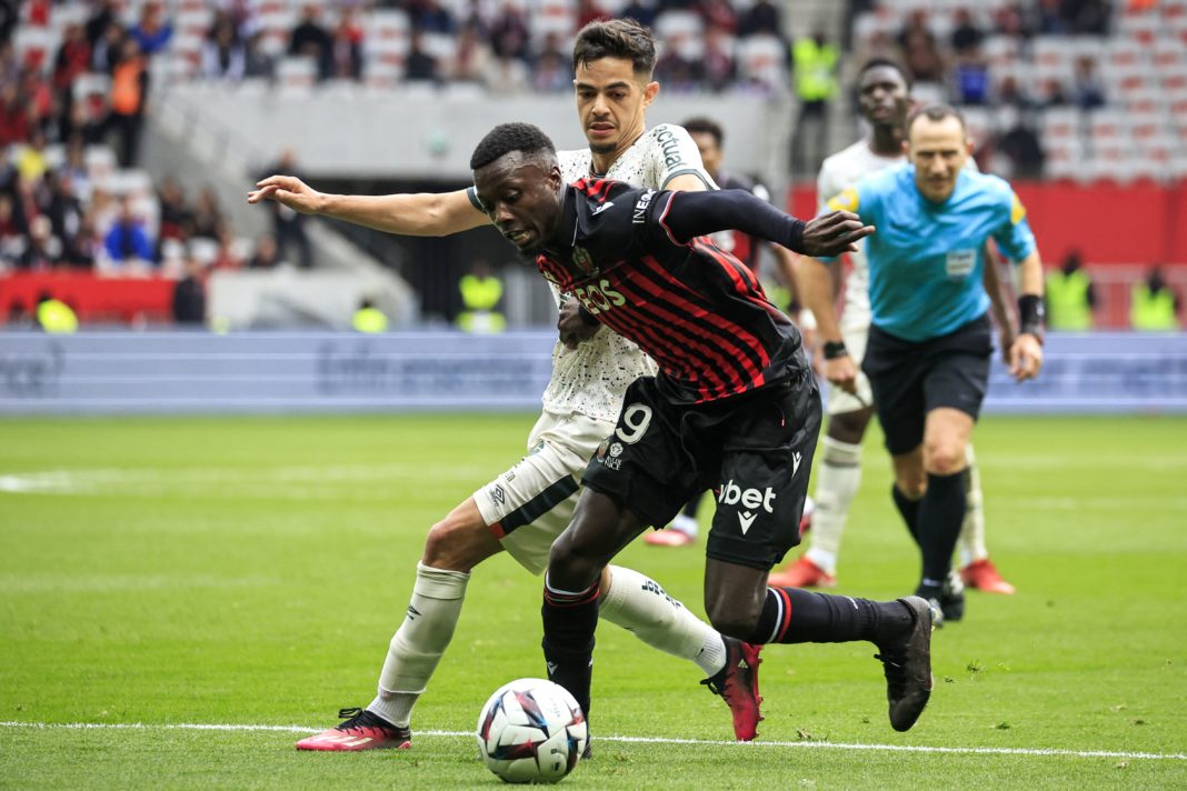 Lorient's French midfielder Romain Faivre (L) fights for the ball with Nice's Ivorian forward Nicolas Pepe during the French L1 football match between OGC Nice and FC Lorient at the Allianz Riviera Stadium in Nice, south-eastern France, on March 19, 2023. (Photo by VALERY HACHE/AFP via Getty Images)