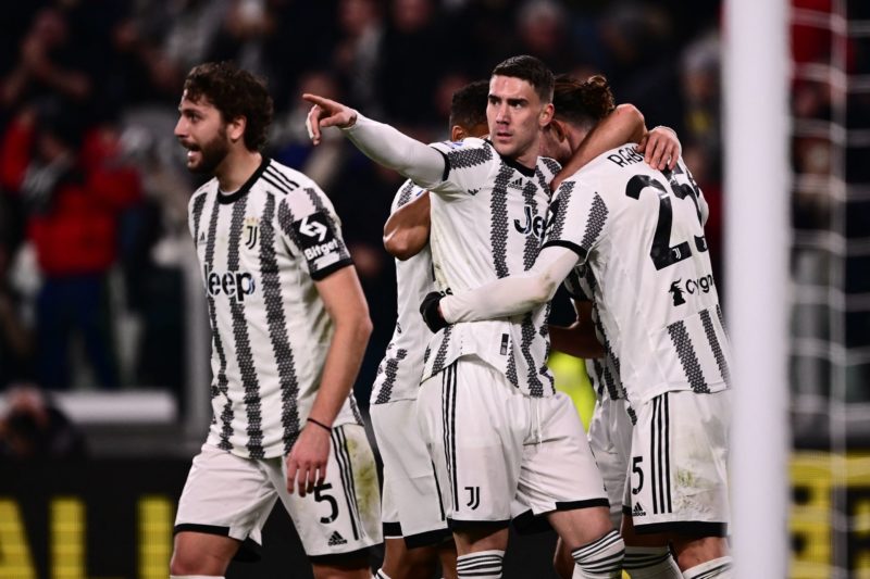 Juventus' French midfielder Adrien Rabiot (R) celebrates with Juventus' Serbian forward Dusan Vlahovic (C) and Juventus' Italian midfielder Manuel Locatelli (L) after opening the scoring during the Italian Serie A football match between Juventus and Fiorentina on February 12, 2023 at the Juventus stadium in Turin.(Photo by MARCO BERTORELLO/AFP via Getty Images)