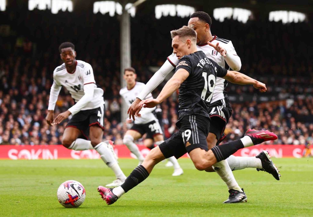 LONDON, ENGLAND - MARCH 12: Leandro Trossard of Arsenal attempts to cross the ball whilst under pressure from Kenny Tete of Fulham during the Premier League match between Fulham FC and Arsenal FC at Craven Cottage on March 12, 2023 in London, England. (Photo by Clive Rose/Getty Images)