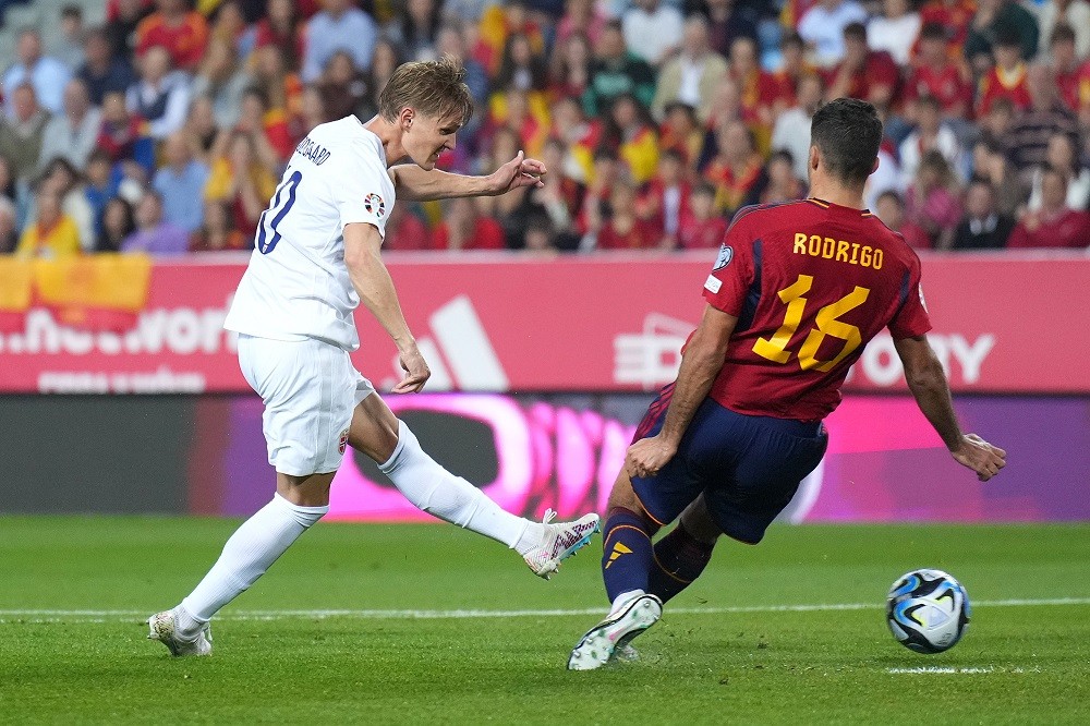 MALAGA, SPAIN: Martin Odegaard of Norway passes the ball whilst under pressure from Rodri of Spain during the UEFA EURO 2024 Qualifying Round Group A match between Spain and Norway at La Rosaleda Stadium on March 25, 2023. (Photo by Angel Martinez/Getty Images)