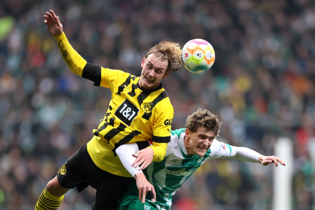 BREMEN, GERMANY - FEBRUARY 11: Julian Brandt of Borussia Dortmund jumps for the ball with Jens Stage of SV Werder Bremen during the Bundesliga match between SV Werder Bremen and Borussia Dortmund at Wohninvest Weserstadion on February 11, 2023 in Bremen, Germany. (Photo by Martin Rose/Getty Images)