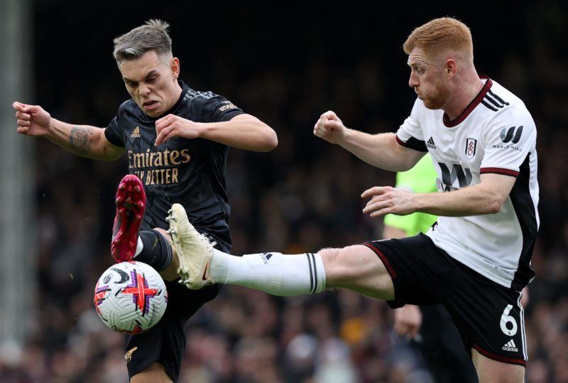  TOPSHOT - Fulham's English midfielder Harrison Reed (R) vies with Arsenal's Belgian midfielder Leandro Trossard during the English Premier League football match between Fulham and Arsenal at Craven Cottage in London on March 12, 2023.(Photo by ADRIAN DENNIS/AFP via Getty Images)