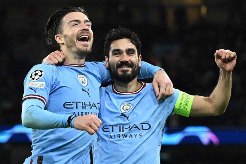 TOPSHOT - Manchester City's German midfielder Ilkay Gundogan (R) celebrates scoring the team's fourth goal with Manchester City's English midfielder Jack Grealish during the UEFA Champions League round of 16 second-leg football match between Manchester City and RB Leipzig at the Etihad Stadium in Manchester, north west England, on March 14, 2023. (Photo by OLI SCARFF/AFP via Getty Images)