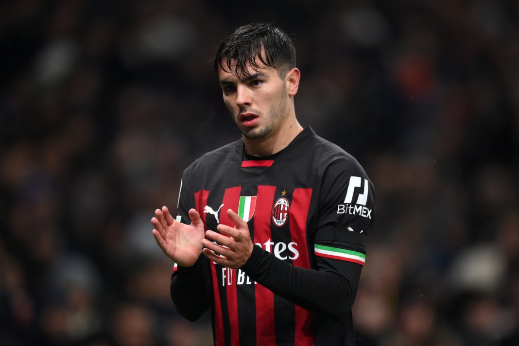 Brahim Diaz of AC Milan clapping to the fans during a UEFA Champions League round of 16 match against Tottenham Hotspur at Tottenham Hotspur Stadium. He wears Milan's red and black jersey and stands on the pitch with his hands raised. The image was taken on March 08, 2023, in London, England, and credit goes to Justin Setterfield/Getty Images.
