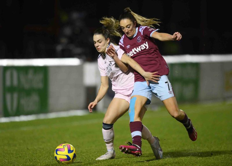 DAGENHAM, ENGLAND - FEBRUARY 05: Giovana Queiroz of Arsenal is challenged by Lisa Evans of West Ham United during the FA Women's Super League match between West Ham United and Arsenal at Chigwell Construction Stadium on February 05, 2023 in Dagenham, England. (Photo by Justin Setterfield/Getty Images)