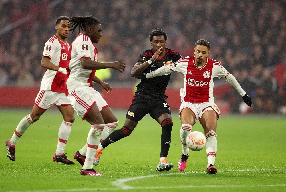 AMSTERDAM, NETHERLANDS: Devyne Rensch and Calvin Bassey of AFC Ajax battle for the ball with Sheraldo Becker of 1.FC Union Berlin during the UEFA Europa League knockout round play-off leg one match between AFC Ajax and 1. FC Union Berlin at Johan Cruyff Arena on February 16, 2023. (Photo by Dean Mouhtaropoulos/Getty Images)