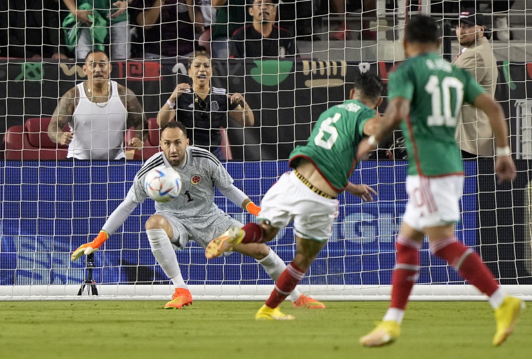 SANTA CLARA, CALIFORNIA - SEPTEMBER 27: Gerardo Arteaga #6 of Mexico shoots and scores past goalie David Ospina #1 of Colombia in the first half of the Mextour Send Off at Levi's Stadium on September 27, 2022 in Santa Clara, California. (Photo by Thearon W. Henderson/Getty Images)