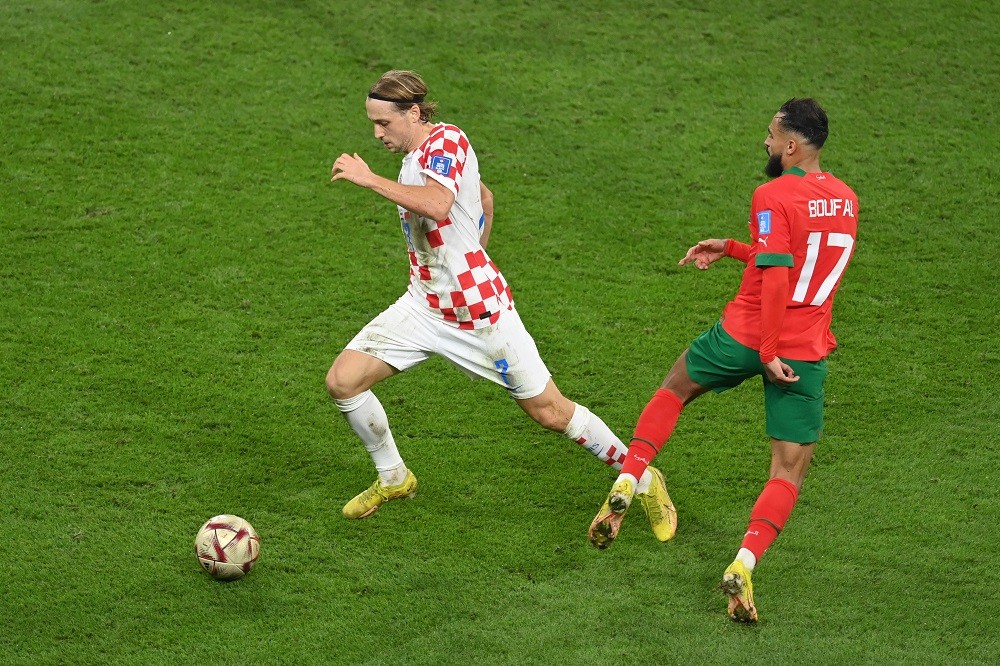 DOHA, QATAR: Lovro Majer of Croatia controls the ball against Sofiane Boufal of Morocco during the FIFA World Cup Qatar 2022 3rd Place match between Croatia and Morocco at Khalifa International Stadium on December 17, 2022. (Photo by Dan Mullan/Getty Images)