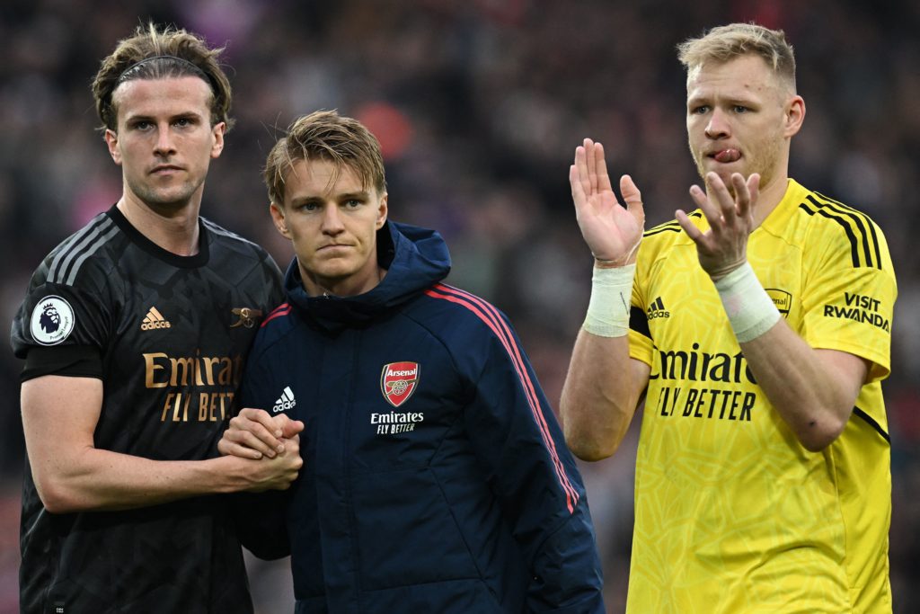 Arsenal's English defender Rob Holding (L), Arsenal's Norwegian midfielder Martin Odegaard (C) and Arsenal's English goalkeeper Aaron Ramsdale applaud the fans following during the English Premier League football match between Liverpool and Arsenal at Anfield in Liverpool, north west England on April 9, 2023. (Photo by PAUL ELLIS/AFP via Getty Images)