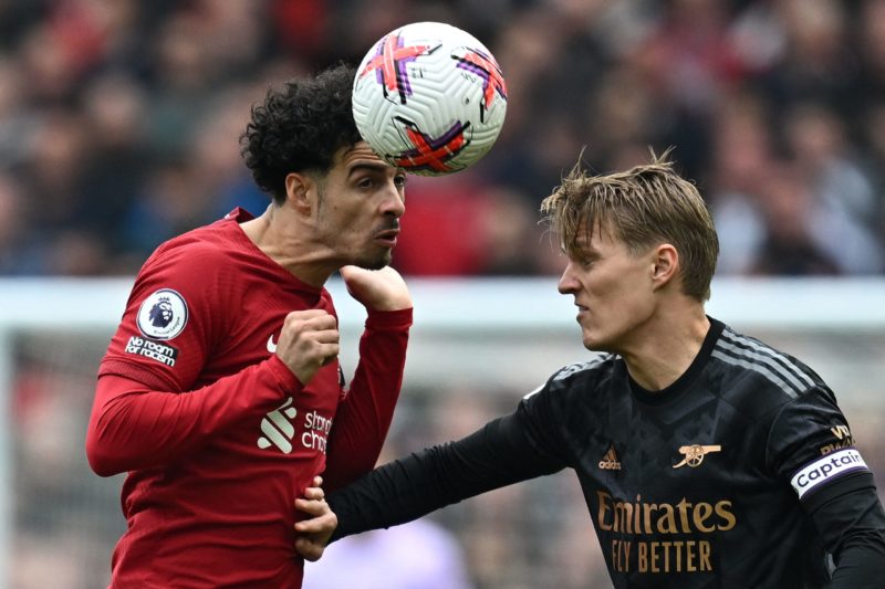 Liverpool's English midfielder Curtis Jones (L) jumps above Arsenal's Norwegian midfielder Martin Odegaard to header the ball during the English Premier League football match between Liverpool and Arsenal at Anfield in Liverpool, north west England on April 9, 2023. (Photo by PAUL ELLIS/AFP via Getty Images)