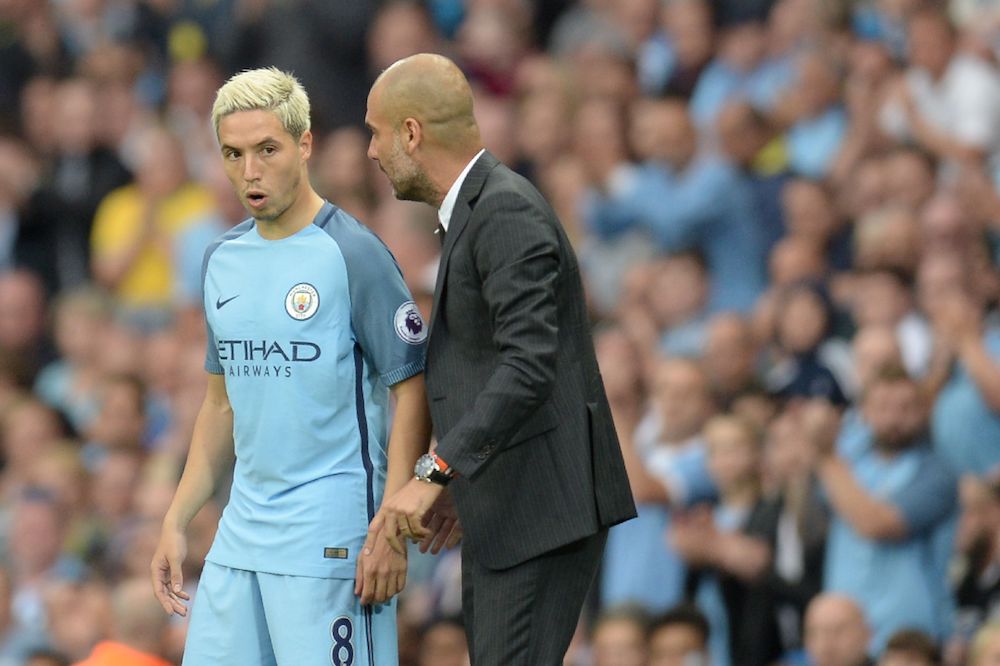 Manchester City's Spanish manager Pep Guardiola talks to Manchester City's French midfielder Samir Nasri (L) on August 28, 2016. (Photo credit should read OLI SCARFF/AFP via Getty Images)