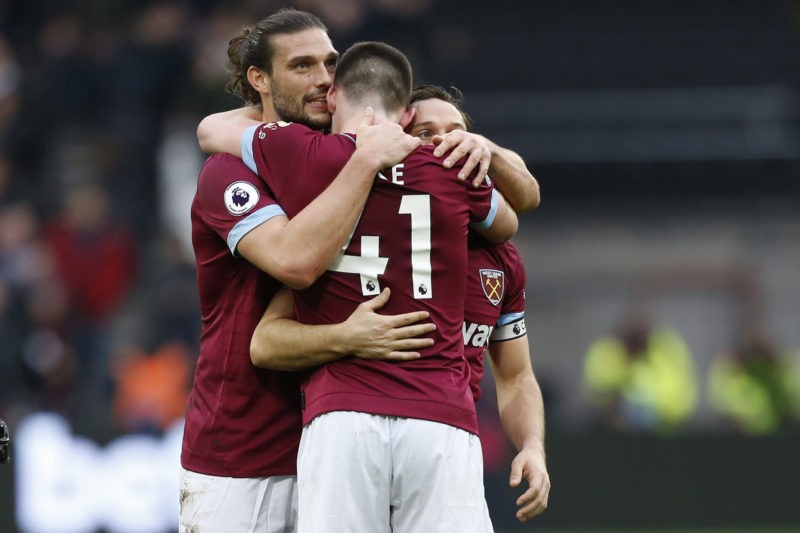 West Ham United's Irish defender Declan Rice (C) embraces West Ham United's English striker Andy Carroll (L) and West Ham United's English midfielder Mark Noble (R) as West Ham players celebrate on the pitch after the English Premier League football match between West Ham United and Arsenal at The London Stadium, in east London on January 12, 2019. (Photo credit should read IAN KINGTON/AFP via Getty Images)