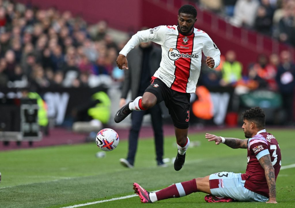 Southampton's English midfielder Ainsley Maitland-Niles (L) is tackled by West Ham United's Italian defender Emerson Palmieri (R) during the English Premier League football match between West Ham United and Southampton at the London Stadium, in London on April 2, 2023.(Photo by GLYN KIRK/AFP via Getty Images)