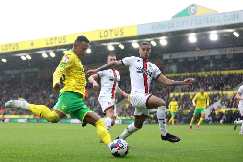 NORWICH, ENGLAND - APRIL 01: Marquinhos of Norwich City shoots under pressure from Max Lowe of Sheffield United during the Sky Bet Championship match between Norwich City and Sheffield United at Carrow Road on April 01, 2023 in Norwich, England. (Photo by Stephen Pond/Getty Images)