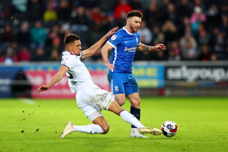 SWANSEA, WALES - FEBRUARY 04:  Nathan Wood of Swansea battles for the ball with Scott Hogan of Birmingham during the Sky Bet Championship between Swansea City and Birmingham City at Liberty Stadium on February 04, 2023 in Swansea, Wales. (Photo by Dan Istitene/Getty Images)