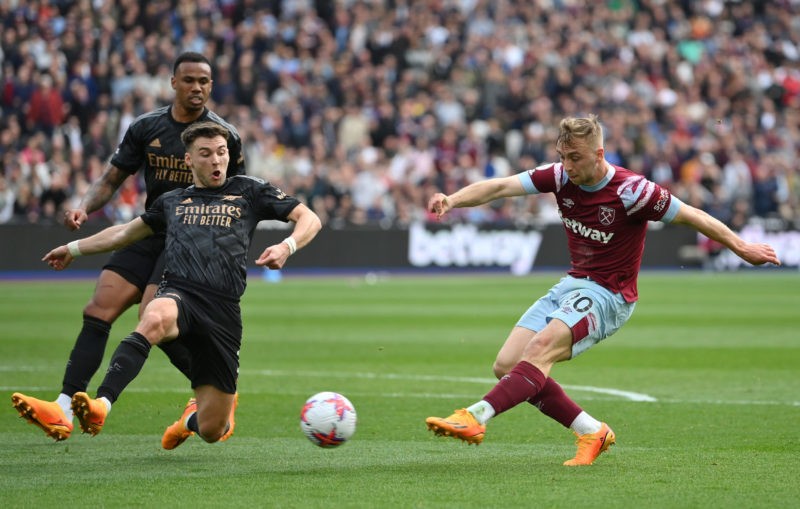 LONDON, ENGLAND - APRIL 16: Jarrod Bowen of West Ham United shoots under pressure from Kieran Tierney of Arsenal during the Premier League match between West Ham United and Arsenal FC at London Stadium on April 16, 2023 in London, England. (Photo by Justin Setterfield/Getty Images)