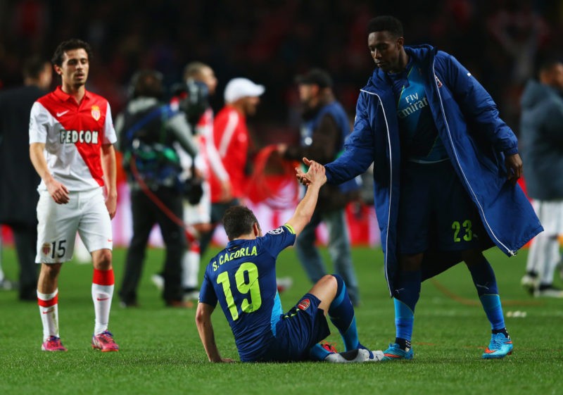 MONACO - MARCH 17: Danny Welbeck of Arsenal consoles team mate Santi Cazorla (19) as they eliminated after the UEFA Champions League round of 16 second leg match between AS Monaco and Arsenal at Stade Louis II on March 17, 2015 in Monaco, Monaco. Arsenal won the match 2-0, but lost on the away goals rule. (Photo by Michael Steele/Getty Images)