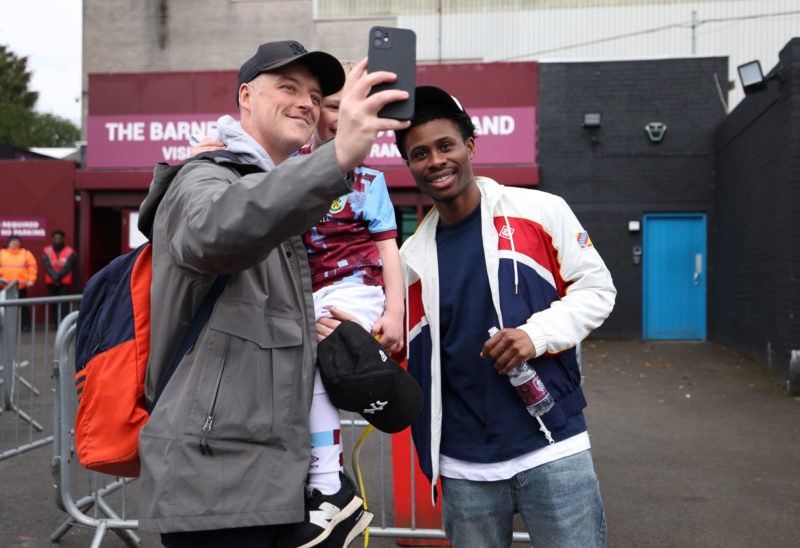 BURNLEY, ENGLAND - APRIL 22: A supporter of Burnley takes a selfie with Nathan Tella of Burnley outside Turf Moor prior to the Sky Bet Championship between Burnley and Queens Park Rangers at Turf Moor on April 22, 2023 in Burnley, England. (Photo by Alex Livesey/Getty Images)