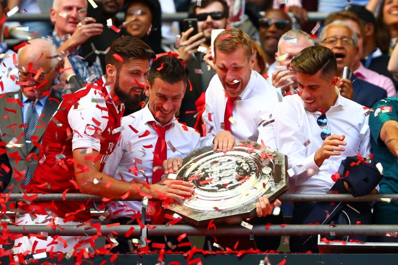 LONDON, ENGLAND - AUGUST 06: (L-R) Olivier Giroud, Laurent Koscielny, Per Mertesacker and Gabriel Paulista of Arsenal celebrate with the FA Community Shield after victory in the FA Community Shield match between Chelsea and Arsenal at Wembley Stadium on August 6, 2017 in London, England. (Photo by Dan Istitene/Getty Images)
