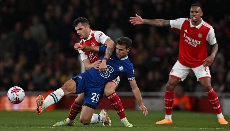Arsenal's Swiss midfielder Granit Xhaka (L) vies with Chelsea's Spanish defender Cesar Azpilicueta during the English Premier League football match between Arsenal and Chelsea at the Emirates Stadium, in London, on May 2, 2023. (Photo by BEN STANSALL/AFP via Getty Images)