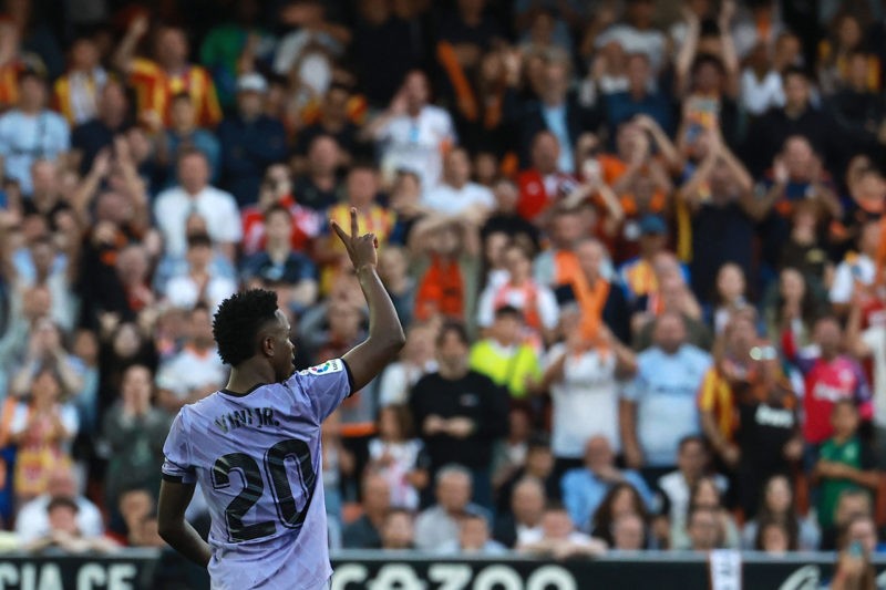 Real Madrid's Brazilian forward Vinicius Junior gestures to the stands during the Spanish league football match between Valencia CF and Real Madrid CF at the Mestalla stadium in Valencia on May 21, 2023. (Photo by JOSE JORDAN/AFP via Getty Images)