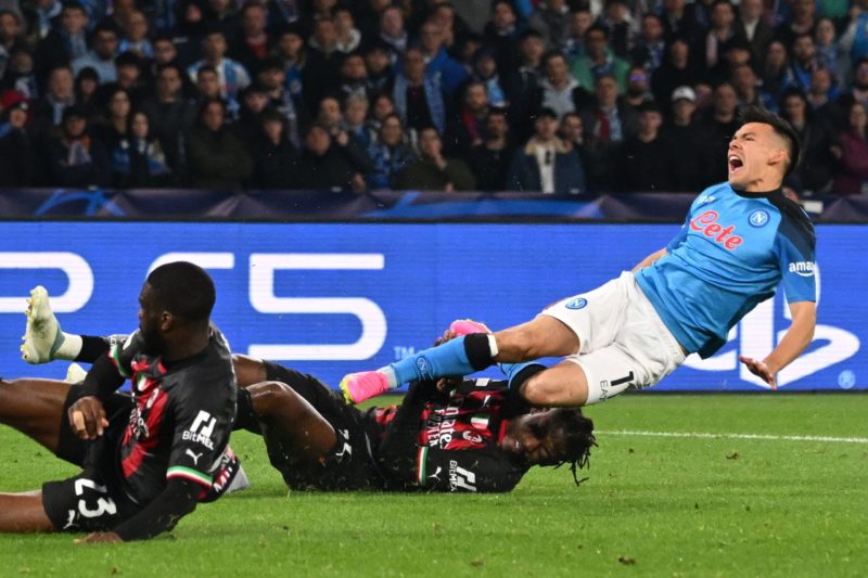 AC Milan's Portuguese forward Rafael Leao (Bottom C) tackles Napoli's Mexican forward Hirving Lozano (R) during the UEFA Champions League quarter-finals second leg football match between SSC Napoli and AC Milan on April 18, 2023 at the Diego-Maradona stadium in Naples. (Photo by ANDREAS SOLARO/AFP via Getty Images)
