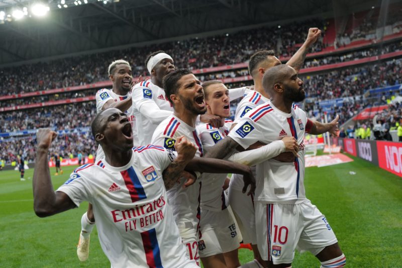 Lyon's French forward Alexandre Lacazette (R) celebrates with teammates after winning the French L1 football match between Olympique Lyonnais (OL) and Montpellier Herault SC at The Groupama Stadium in Decines-Charpieu, central-eastern France on May 7, 2023.(Photo by OLIVIER CHASSIGNOLE/AFP via Getty Images)