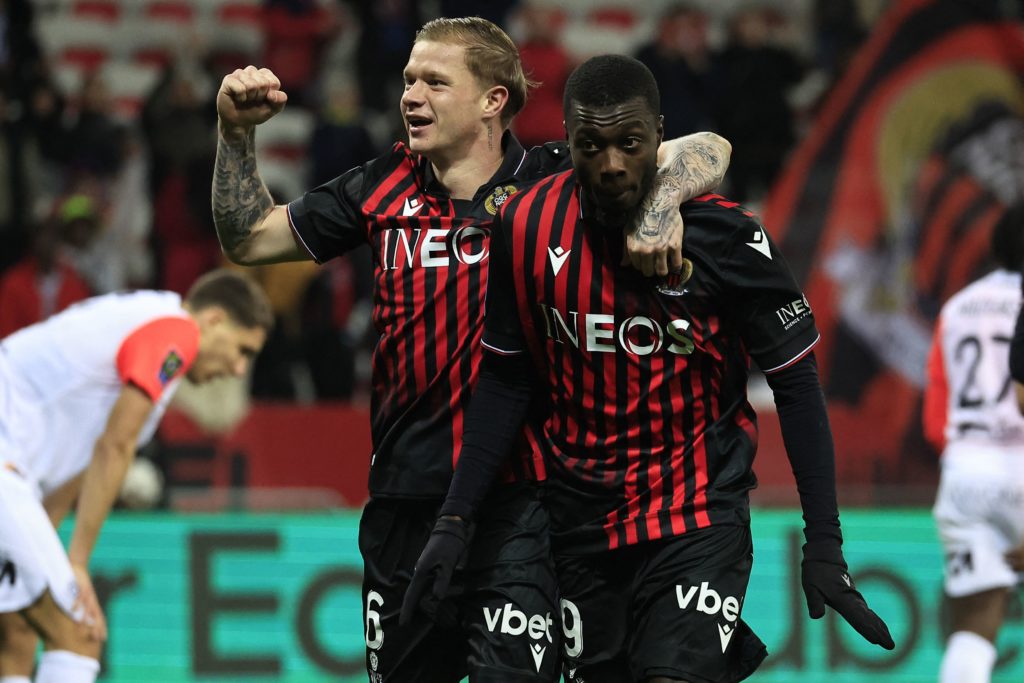 Nice's Ivorian forward Nicolas Pepe (R) celebrates with Nice's French defender Melvin Bard after scoring his team's third goal during the French L1 football match between OGC Nice and Montpellier Herault SC at the Allianz Riviera Stadium in Nice, south-eastern France, on January 11, 2023. (Photo by VALERY HACHE/AFP via Getty Images)