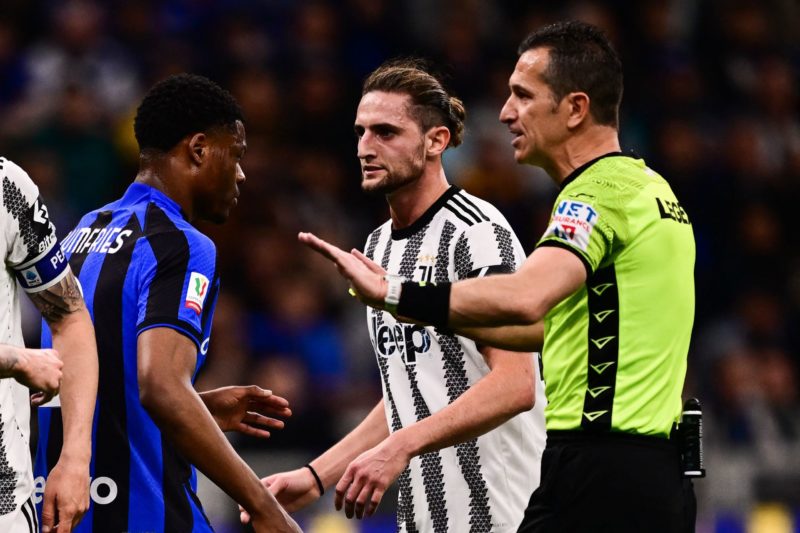 Italian referee Daniele Doveri (R) argues with Inter Milan's Dutch midfielder Denzel Dumfries (L) next to Juventus' French midfielder Adrien Rabiot (C) during the Italian Cup semi-final second leg football match between Inter Milan and Juventus at the Giuseppe-Meazza (San Siro) stadium in Milan, on April 26, 2023. (Photo by Marco BERTORELLO / AFP) (Photo by MARCO BERTORELLO/AFP via Getty Images)