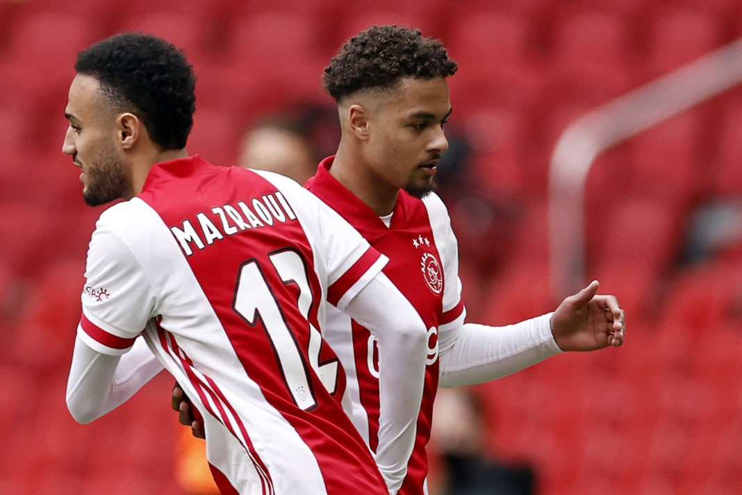 Ajax's defender Noussair Mazraoui (L) and Ajax's defender Devyne Rensch react during the Dutch Eredivisie match between Ajax Amsterdam and FC Emmen at the Johan Cruijff Arena in Amsterdam, The Netherlands, on May 2, 2021. - Ajax Amsterdam clinched their 35th Dutch league title on Sunday with a 4-0 victory over Emmen. - Netherlands OUT (Photo by MAURICE VAN STEEN / ANP / AFP) / Netherlands OUT (Photo by MAURICE VAN STEEN/ANP/AFP via Getty Images)
