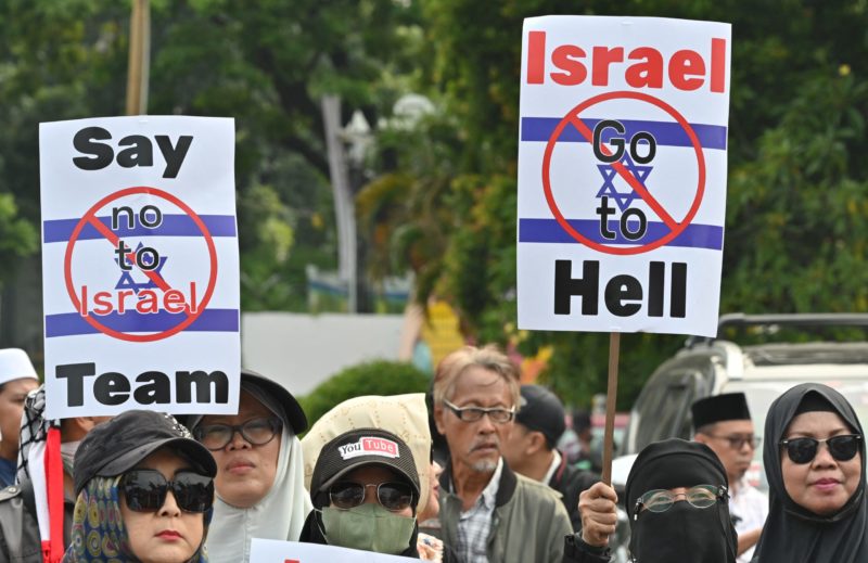 This picture taken in Jakarta on March 20, 2023 shows Muslim people participating in a protest to reject the football national team of Israel for the 2023 World Cup Under20 in Jakarta. (Photo by ADEK BERRY/AFP via Getty Images)