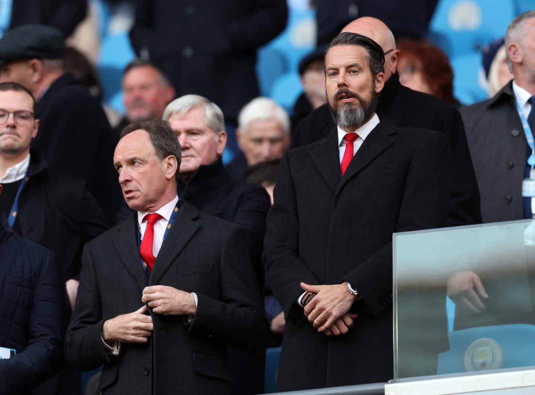 MANCHESTER, ENGLAND: Josh Kroenke (R) Director of Arsenal looks on from the stands ahead of the Premier League match between Manchester City and Arsenal FC at Etihad Stadium on April 26, 2023. (Photo by Catherine Ivill/Getty Images)