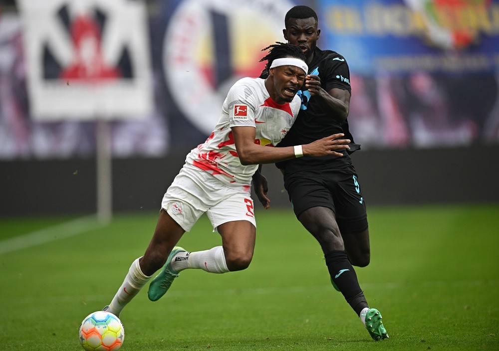 LEIPZIG, GERMANY: Mohamed Simakan of Leipzig is challenged by Ihlas Bebou of Hoffenheim during the Bundesliga match between RB Leipzig and TSG Hoffenheim at Red Bull Arena on April 29, 2023. (Photo by Stuart Franklin/Stuart Franklin/Getty Images)