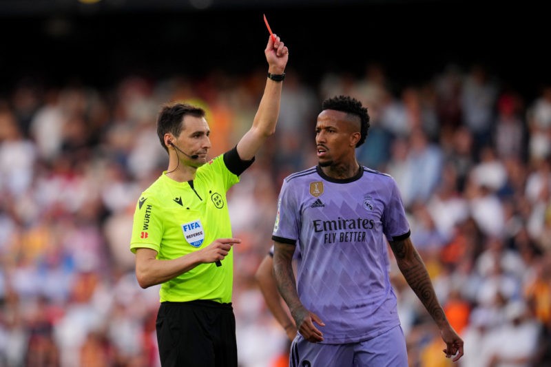 VALENCIA, SPAIN - MAY 21: Match Referee Ricardo de Burgos Bengoetxea shows a red card to Vinicius Junior of Real Madrid (not pictured) as his teammate Eder Militao reacts during the LaLiga Santander match between Valencia CF and Real Madrid CF at Estadio Mestalla on May 21, 2023 in Valencia, Spain. (Photo by Aitor Alcalde/Getty Images)