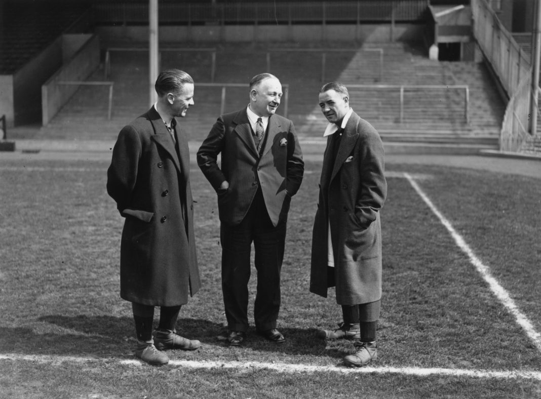 13th April 1932: Arsenal Football Club Manager Herbert Chapman (centre), chats with a key member of his team , Alex James (right), on the pitch at Wembley before the FA Cup final. (Photo by J. Gaiger/Topical Press Agency/Getty Images)