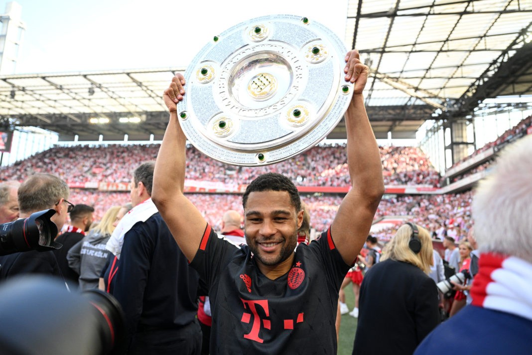 COLOGNE, GERMANY - MAY 27: Serge Gnabry of FC Bayern Munich poses for a photo with the Bundesliga Meisterschale trophy after the team's victory in the Bundesliga match between 1. FC Köln and FC Bayern München at RheinEnergieStadion on May 27, 2023 in Cologne, Germany. (Photo by Matthias Hangst/Getty Images)