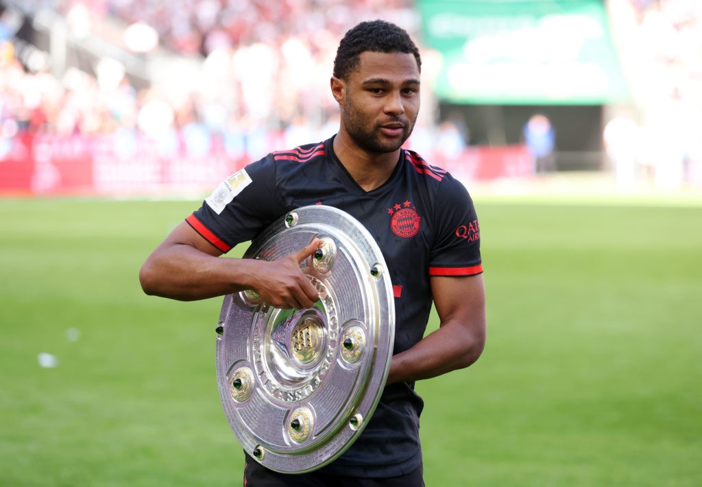 COLOGNE, GERMANY - MAY 27: Serge Gnabry of FC Bayern Munich poses for a photo with the Bundesliga Meisterschale trophy after the team's victory in the Bundesliga match between 1. FC Köln and FC Bayern München at RheinEnergieStadion on May 27, 2023 in Cologne, Germany. (Photo by Alexander Hassenstein/Getty Images)