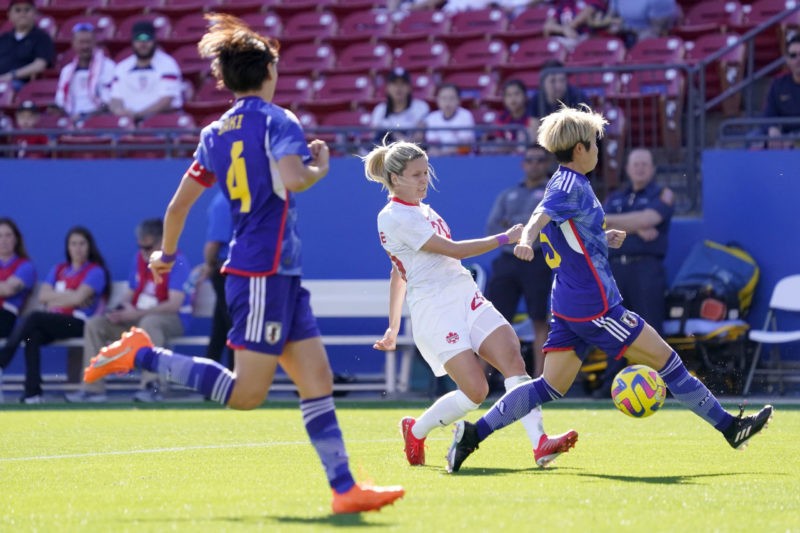 FRISCO, TEXAS - FEBRUARY 22: Cloé Lacasse #20 of Canada shoots the ball past Shiori Miyake #5 of Japan during the first half of a 2023 SheBelieves Cup match at Toyota Stadium on February 22, 2023 in Frisco, Texas. (Photo by Sam Hodde/Getty Images)
