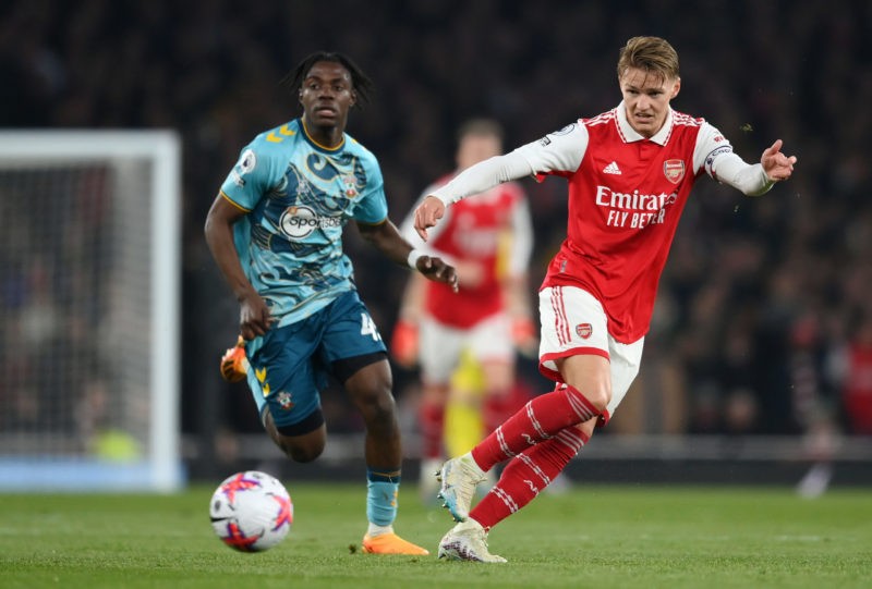 LONDON, ENGLAND - APRIL 21: Martin Odegaard of Arsenal passes the ball under pressure from Romeo Lavia of Southampton during the Premier League match between Arsenal FC and Southampton FC at Emirates Stadium on April 21, 2023 in London, England. (Photo by Shaun Botterill/Getty Images)