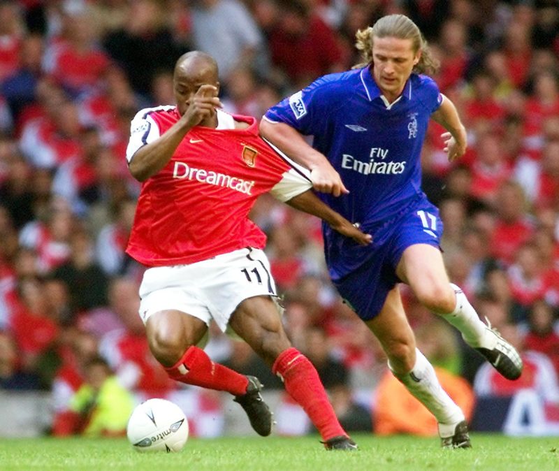 CARDIFF, UNITED KINGDOM: Chelsea's Emmanuel Petit pulls the shirt of Arsenal's Sylvain Wiltord 04 May 2002 during the F.A. Cup final soccer match at The Millennium Stadium in Cardiff. (Photo credit GERRY PENNY/AFP via Getty Images)